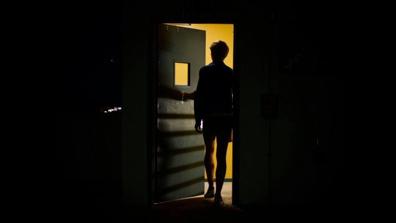 Figura sulla soglia di una porta illuminata — corso live sul sabotatore interno